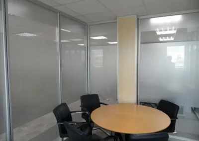 Divisorias para oficinas en cristal laminar 5+5 mm. con puerta de melamina y lámina de vinilo opaco